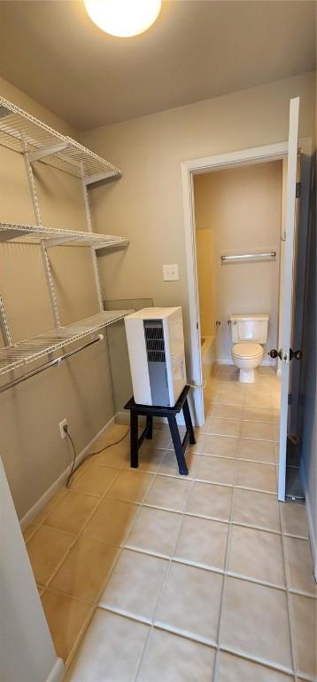 clothes washing area with tile patterned floors