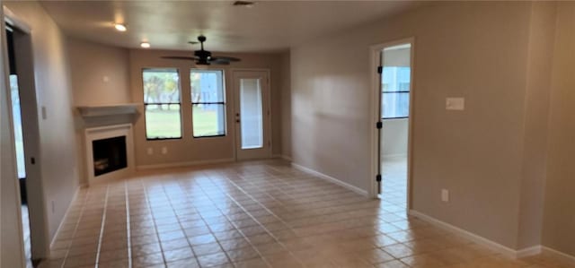 unfurnished living room featuring ceiling fan and light tile patterned flooring