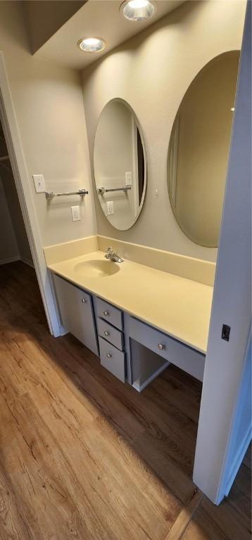 bathroom featuring wood-type flooring and vanity