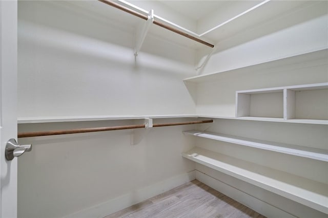 spacious closet with light hardwood / wood-style floors