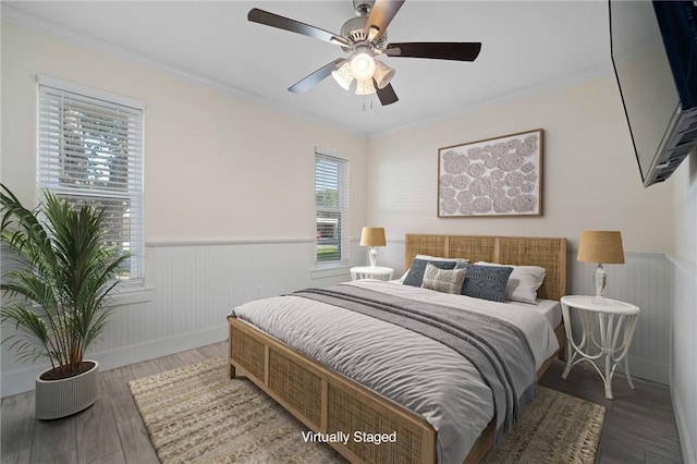 bedroom featuring ornamental molding, dark hardwood / wood-style floors, and ceiling fan