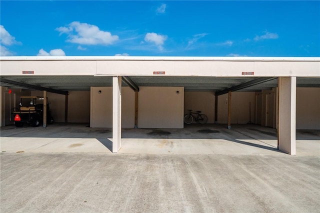 view of parking / parking lot featuring a carport