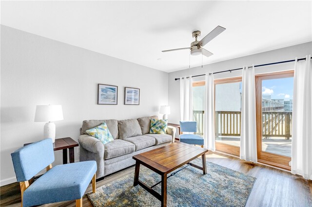 living room with hardwood / wood-style floors and ceiling fan