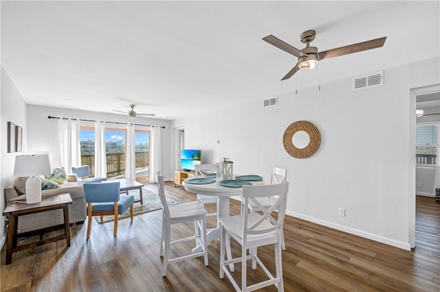 dining space with ceiling fan and dark hardwood / wood-style floors