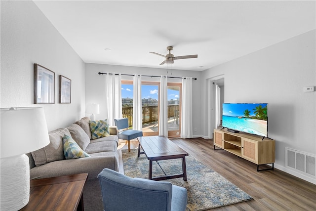 living room featuring hardwood / wood-style floors and ceiling fan