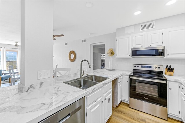 kitchen featuring white cabinetry, light hardwood / wood-style floors, appliances with stainless steel finishes, and sink