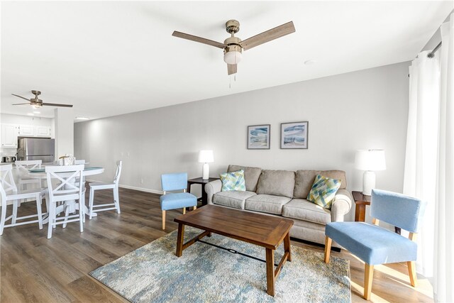 living room with ceiling fan and dark hardwood / wood-style floors