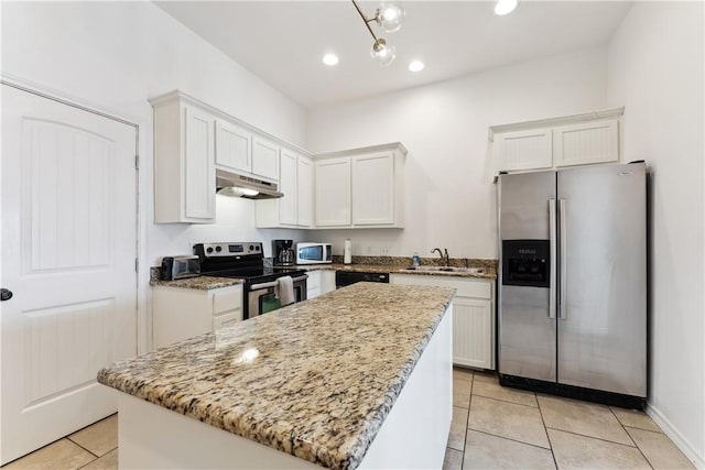 14334 Cruiser St Unit 101, Corpus Christi, TX 78418 - kitchen with stainless steel appliances, under cabinet range hood, light tile patterned floors, white cabinetry, and recessed lighting