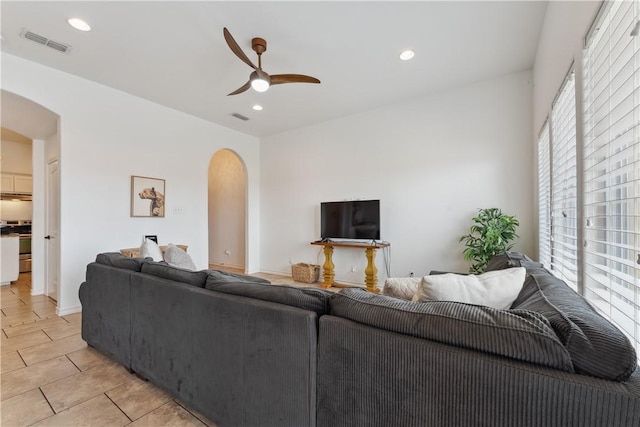 14334 Cruiser St Unit 101, Corpus Christi, TX 78418 - living area featuring arched walkways, a ceiling fan, healthy amount of natural light, light tile patterned flooring, and recessed lighting