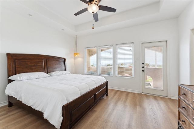 14334 Cruiser St Unit 101, Corpus Christi, TX 78418 - bedroom featuring access to outside, light wood-style floors, a tray ceiling, and multiple windows