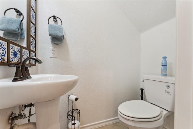 14334 Cruiser St Unit 101, Corpus Christi, TX 78418 - half bathroom featuring toilet and vaulted ceiling
