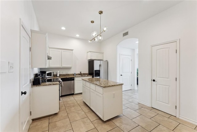 14334 Cruiser St Unit 101, Corpus Christi, TX 78418 - kitchen with stainless steel appliances, arched walkways, a kitchen island, light tile patterned flooring, and recessed lighting