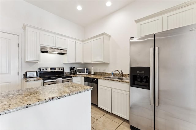 14334 Cruiser St Unit 101, Corpus Christi, TX 78418 - kitchen featuring appliances with stainless steel finishes, under cabinet range hood, recessed lighting, light tile patterned floors, and light stone counters