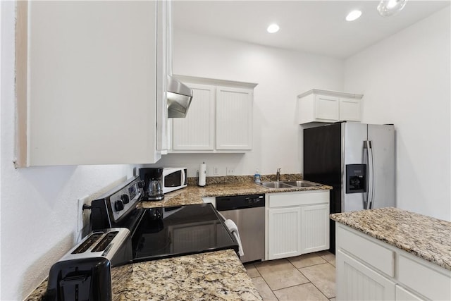 14334 Cruiser St Unit 101, Corpus Christi, TX 78418 - kitchen featuring stainless steel appliances, white cabinetry, ventilation hood, light tile patterned floors, and recessed lighting