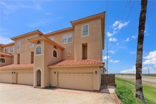 14334 Cruiser St Unit 101, Corpus Christi, TX 78418 - mediterranean / spanish-style home with stucco siding, a garage, and a tile roof