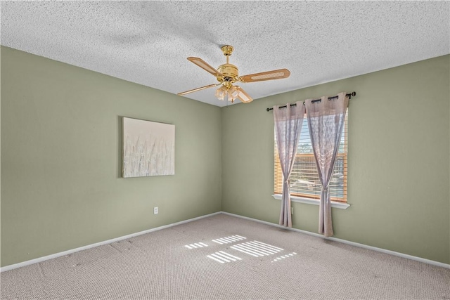 carpeted empty room featuring a textured ceiling, baseboards, and ceiling fan