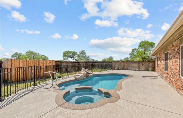view of swimming pool with a patio, a pool with connected hot tub, and a fenced backyard