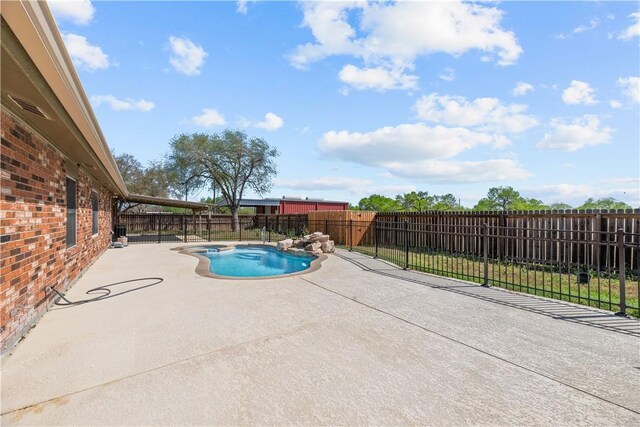 view of pool featuring a patio area, a fenced in pool, and a fenced backyard