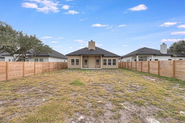 rear view of house with a lawn