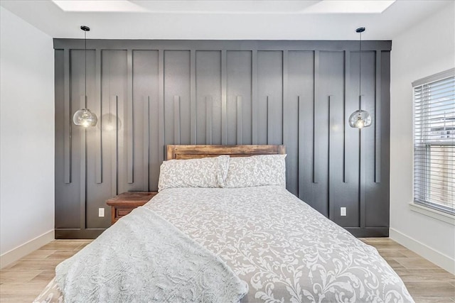 bedroom featuring light hardwood / wood-style floors and a skylight