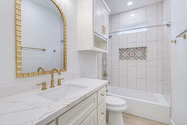 full bathroom with toilet, tiled shower / bath combo, and vanity