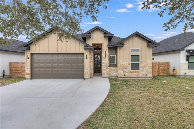 view of front of home with a front lawn and a garage