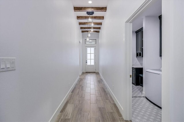 hallway featuring beam ceiling and washer / clothes dryer