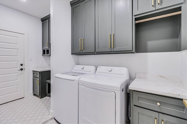 laundry room with cabinets and separate washer and dryer