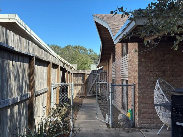 3321 Casa Bonita Dr, Corpus Christi, TX 78411 - view of home's exterior featuring brick siding, fence, and a gate