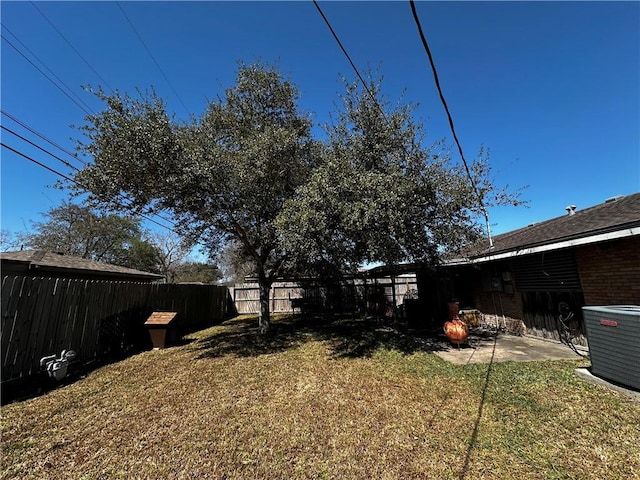 view of yard featuring a patio, a fenced backyard, and central air condition unit