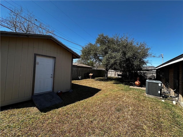 view of yard featuring a fenced backyard and central air condition unit