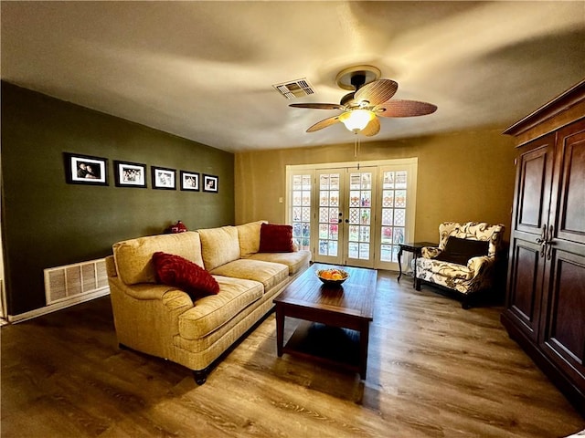 living area with dark wood-type flooring, french doors, visible vents, and ceiling fan