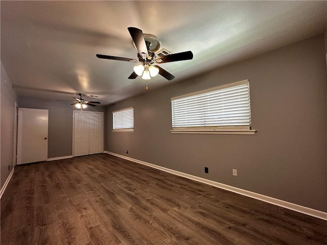 3321 Casa Bonita Dr, Corpus Christi, TX 78411 - unfurnished bedroom with a closet, baseboards, a ceiling fan, and dark wood finished floors