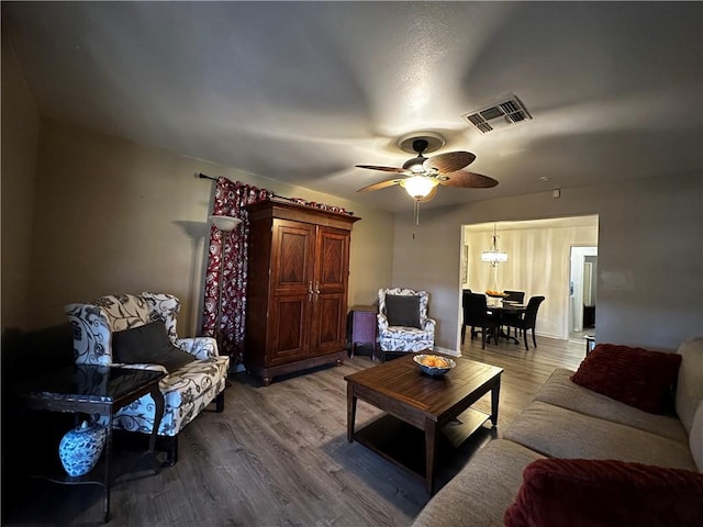 living area featuring ceiling fan, wood finished floors, and visible vents