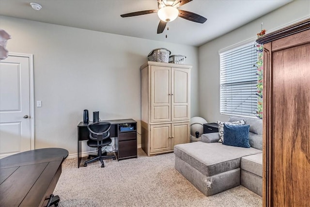 office featuring ceiling fan and light carpet