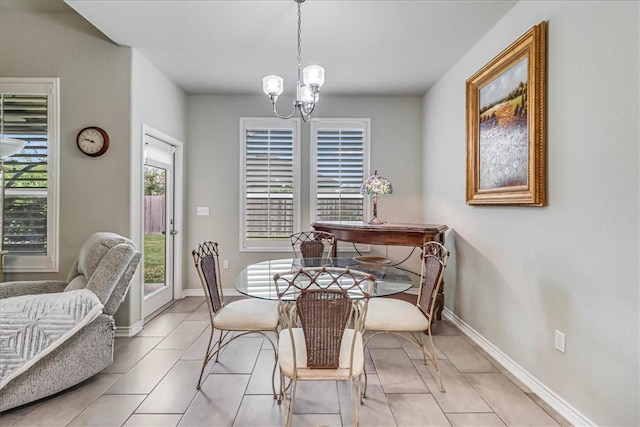 dining space with light tile patterned flooring and a chandelier