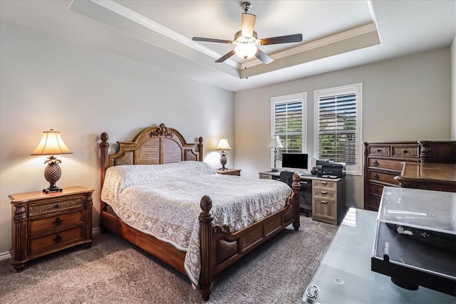 carpeted bedroom featuring a tray ceiling and ceiling fan