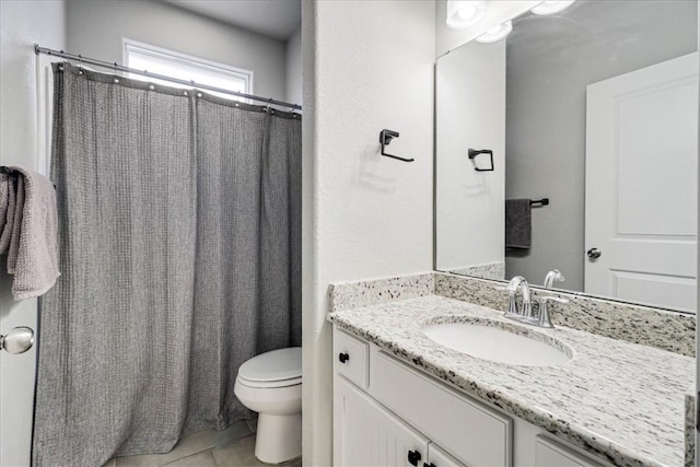 bathroom with tile patterned flooring, vanity, and toilet