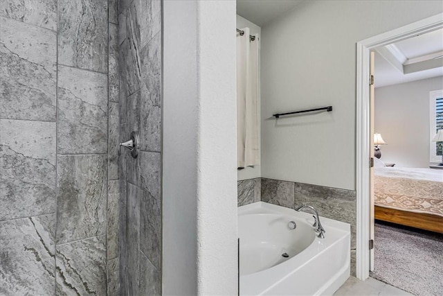 bathroom featuring tile patterned flooring and a tub