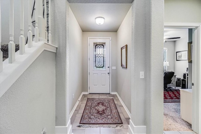 doorway featuring light carpet