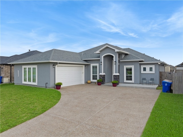 view of front of house featuring a garage and a front lawn