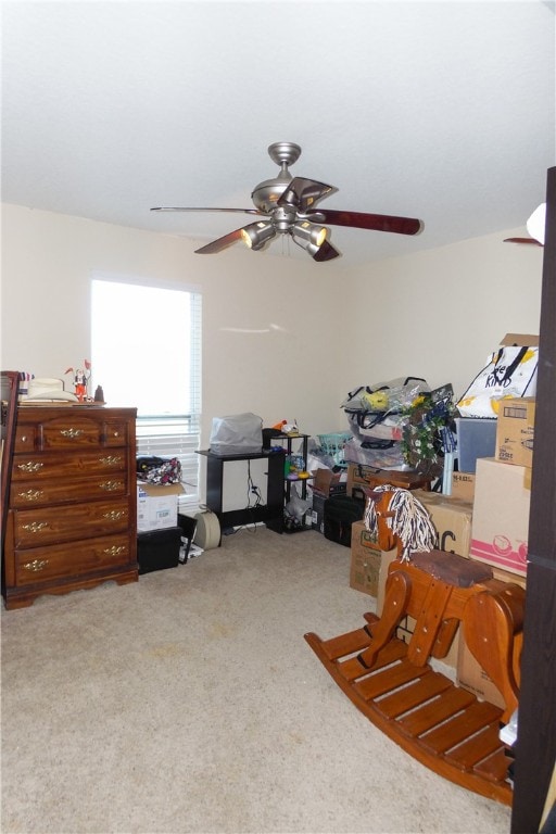 interior space with carpet flooring and ceiling fan