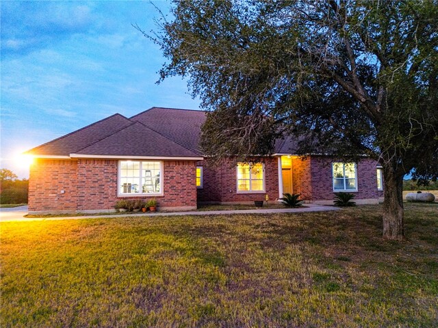 ranch-style home with a front lawn