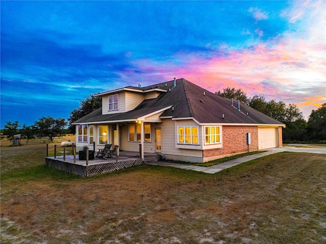 exterior space featuring a porch, a yard, and a garage