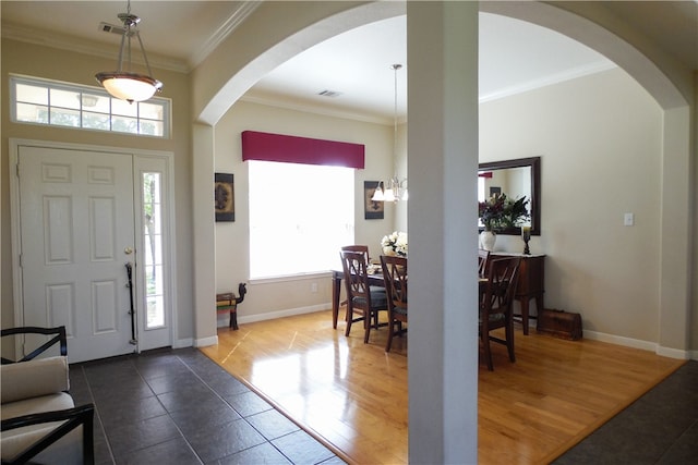 entryway with wood-type flooring and ornamental molding