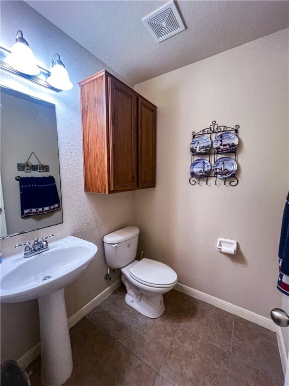 bathroom with tile patterned flooring and toilet