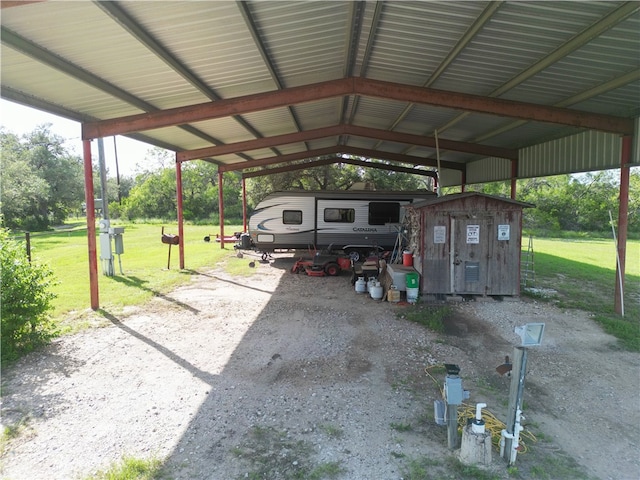 view of vehicle parking with a yard and a carport