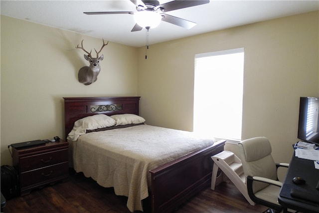 bedroom with dark hardwood / wood-style flooring and ceiling fan