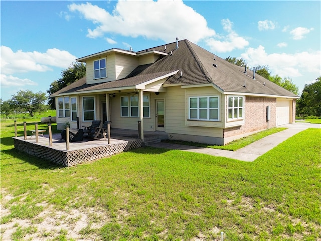 back of property with a garage, a deck, and a yard