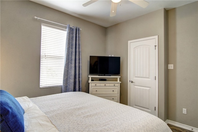 bedroom featuring wood-type flooring, multiple windows, and ceiling fan